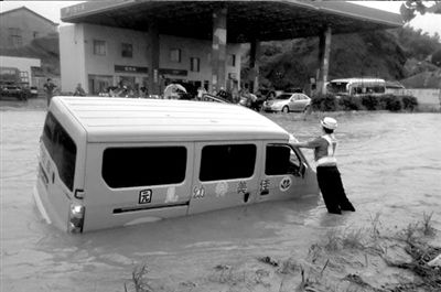 女交警雨中撐側(cè)傾校車(chē) 受訪稱不應(yīng)突出個(gè)人（圖）