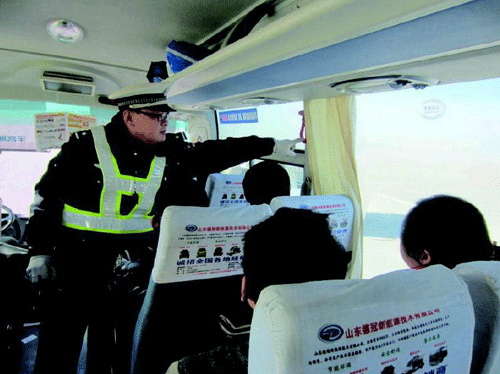 執勤交警現場檢查客運車輛安全設施